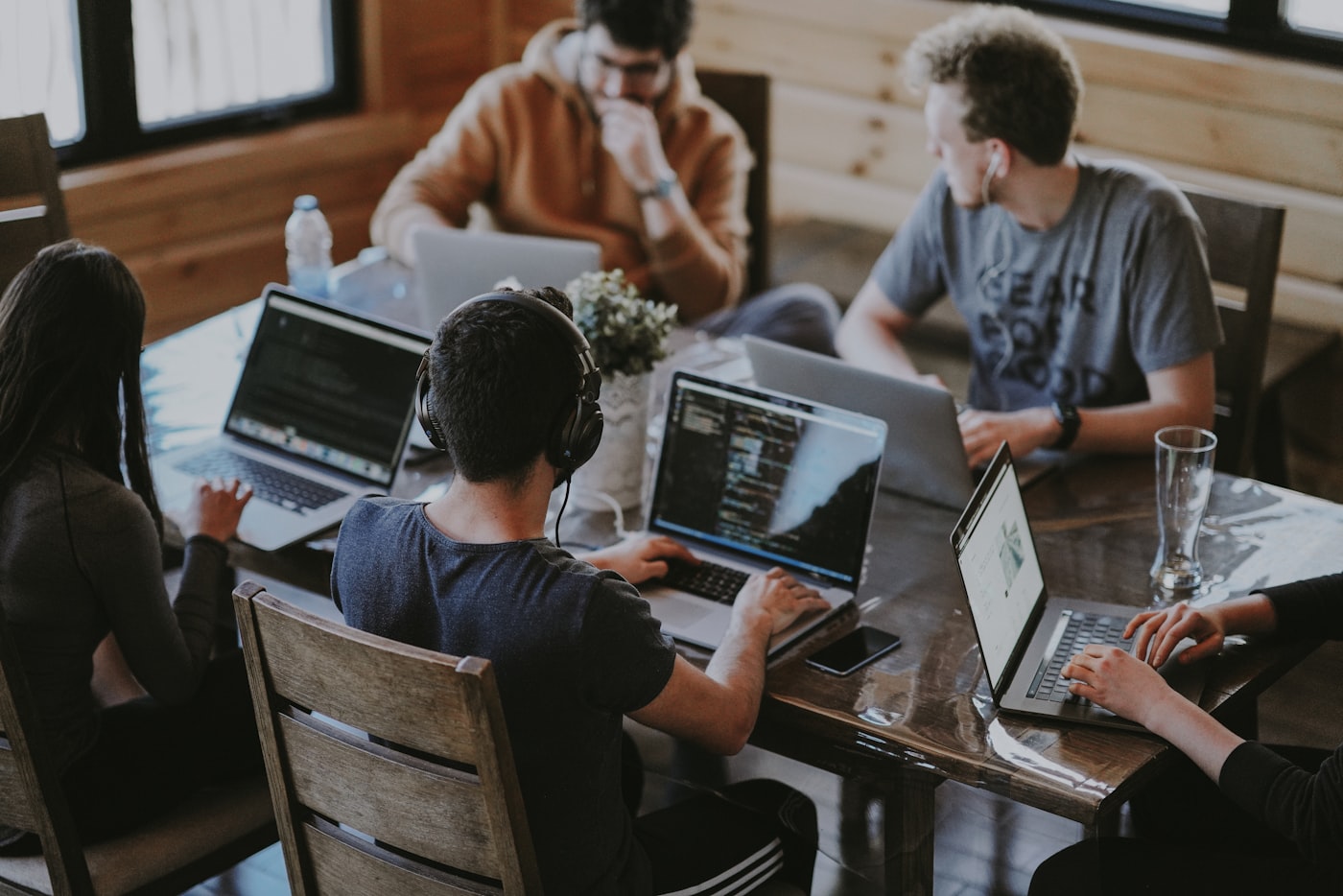 The team reviewing work together around a laptop